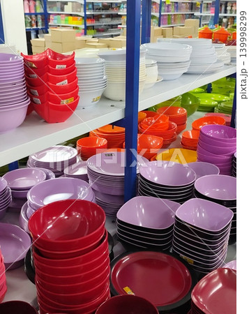 pile of plastic bowls and plates in the shop pile of plastic bowls and plates in the shop 139998299