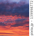 Vertical dramatic sunset sky with vibrant orange and dark purple clouds 139998772