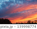 Colorful fiery sunset sky with dramatic clouds over rural landscape 139998774