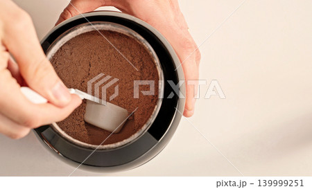 Top View Male Hands Scooping Chocolate Whey Protein Powder From Container, Fitness Nutrition And Supplement Routine Concept 139999251