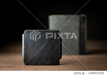 Handmade black wallet made of genuine leather on a wooden background. Close-up, top view. Handmade black wallet made of genuine leather on a wooden background. Close-up, top view. 140001092