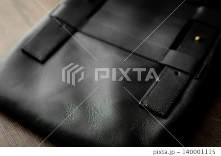 Fashionable mens bag, men purse, wallet men's casual outfits with leather accessories, brown bag on wooden board background Fashionable mens bag, men purse, wallet men's casual outfits with leather accessories, brown bag on wooden board background 140001115