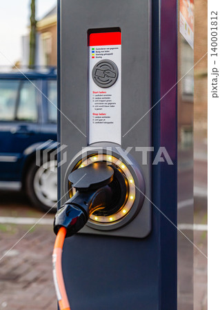 Electric vehicle charging station in a city setting Electric vehicle charging station in a city setting 140001812