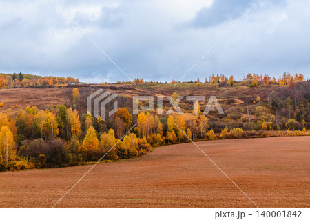 Vibrant autumn landscape with colorful foliage and rolling hills in a serene countryside setting Vibrant autumn landscape with colorful foliage and rolling hills in a serene countryside setting 140001842