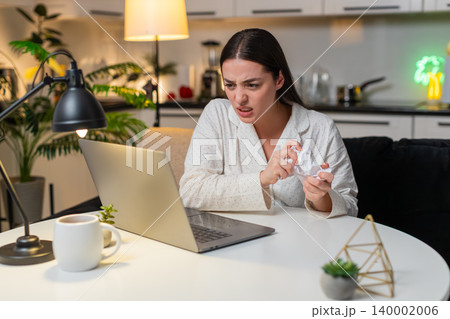 Young woman angry at utility bill crumples receipt throws papers worries about big charges evening Young woman angry at utility bill crumples receipt throws papers worries about big charges evening 140002006
