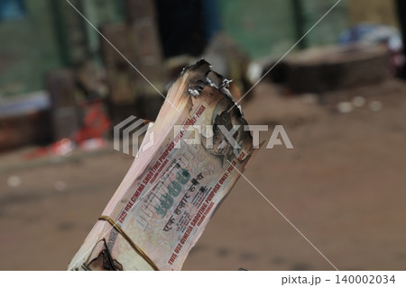 Burning Indian Currency closeup Burning Indian Currency closeup 140002034
