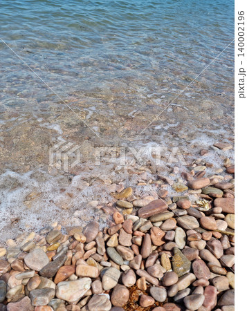 It is a beach with round pebbles. It is a beach with round pebbles. 140002196