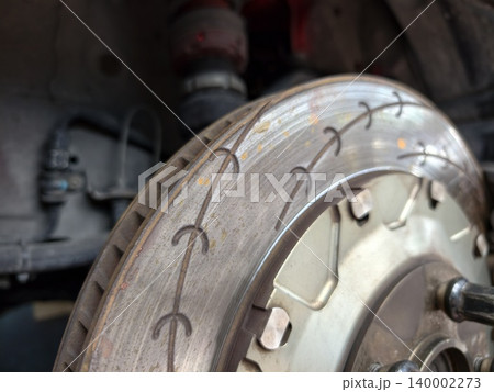 Close-up of high performance slotted car brake rotor disc 140002273