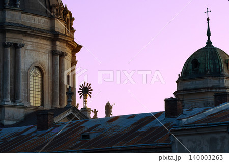 Romantic sunset illuminates ancient European cathedral dome and architecture 140003263