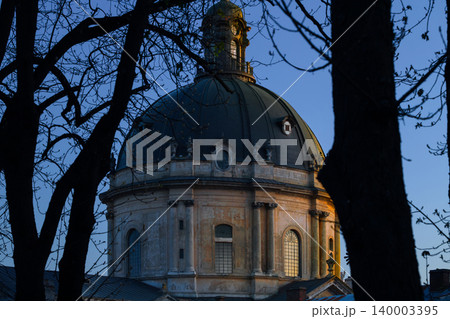 aged cathedral dome in twilight low key view with bare branches of autumn depressive dusk aged cathedral dome in twilight low key view with bare branches of autumn depressive dusk 140003395