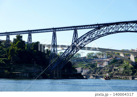 Low angle view of Maria Pia Bridge and Infante Bridge over the Douro River in Porto, Portugal Low angle view of Maria Pia Bridge and Infante Bridge over the Douro River in Porto, Portugal 140004317