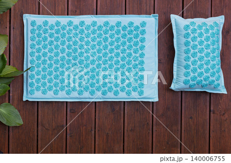 Blue Acupressure Mat and Pillow on Wood 140006755
