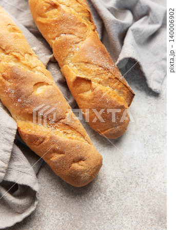 Fresh crisp baguettes on rustic linen cloth Fresh crisp baguettes on rustic linen cloth 140006902