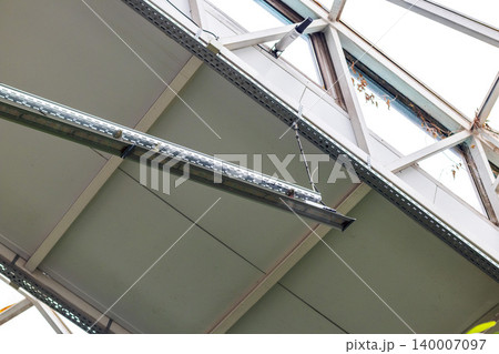 An indoor tropical garden or greenhouse atrium setting illuminated by artificial overhead lighting An indoor tropical garden or greenhouse atrium setting illuminated by artificial overhead lighting 140007097