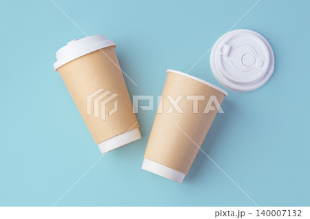 Paper takeaway cup with lid on pastel blue background 140007132