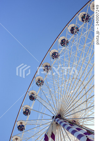 A dizzying ride and blue skies at a funfair A dizzying ride and blue skies at a funfair 140007249