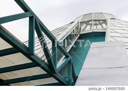 Modern Architectural Roof Detail with Slanted Panels and Teal Steel Truss Modern Architectural Roof Detail with Slanted Panels and Teal Steel Truss 140007880