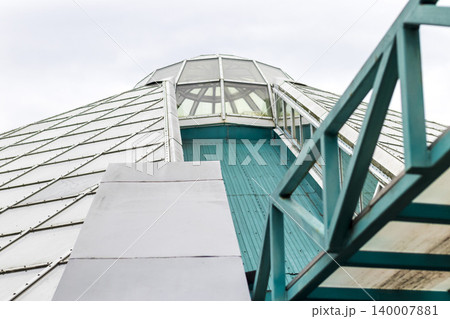 Modern Architectural Roof Detail with Slanted Panels and Teal Steel Truss 140007881