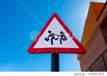 School Crossing Traffic Sign with Building and Blue Sky 140007920