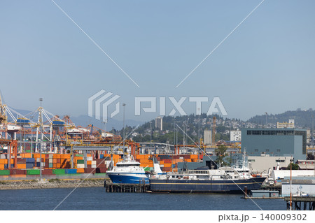 Cargo ship at container port loading global trade goods Cargo ship at container port loading global trade goods 140009302