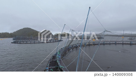 Large fish farm in the water with nets under cloudy sky as background 140009308