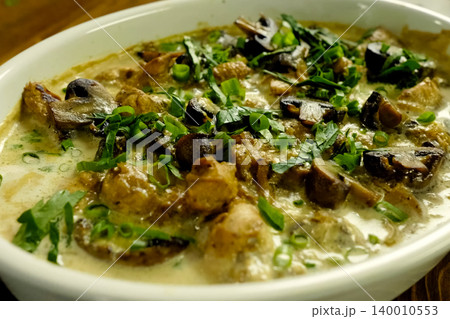 Fried chicken with mushrooms, milk and onions. Fried chicken with mushrooms, milk and onions. 140010553