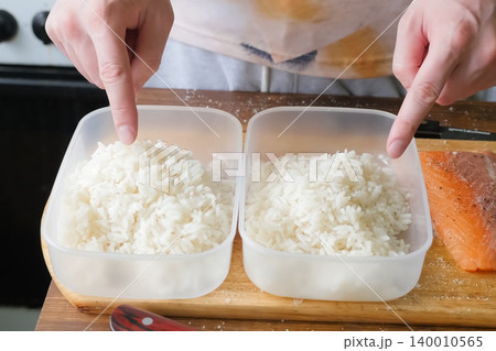 Rice porridge in plastic containers, preparing food 140010565