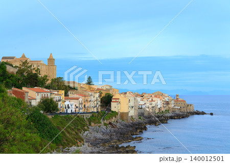 Picturesque European coastal town with historic buildings overlooking the sea Picturesque European coastal town with historic buildings overlooking the sea 140012501