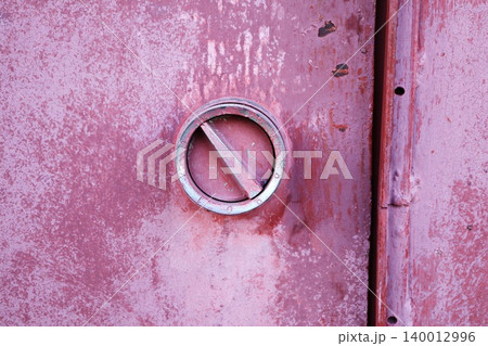 Round Metal Round Handle on Weathered Pink Red Metal Surface, Industrial Hardware Texture Background Round Metal Round Handle on Weathered Pink Red Metal Surface, Industrial Hardware Texture Background 140012996