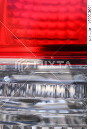 Abstract Macro of Red and Clear Car Tail Light with Geometric Pattern and Reflections, Automotive Detail Abstract Macro of Red and Clear Car Tail Light with Geometric Pattern and Reflections, Automotive Detail 140013004