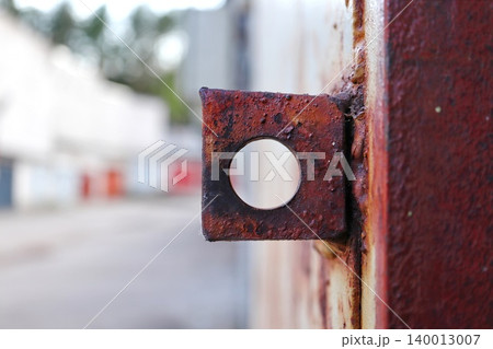 Heavily Rusted Square Metal Bracket with Circular Hole, Weathered Industrial Hardware Detail with Bokeh Background Heavily Rusted Square Metal Bracket with Circular Hole, Weathered Industrial Hardware Detail with Bokeh Background 140013007