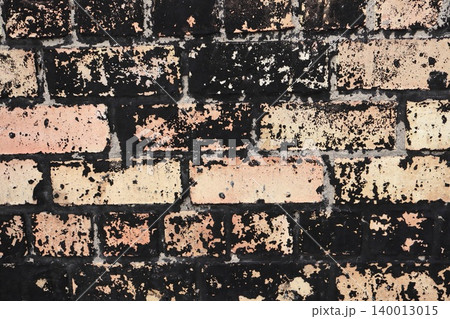 Black Painted Brick Wall with Peeling Paint Revealing Terracotta, Weathered Urban Grunge Texture Background 140013015