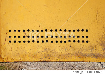 Yellow Orange Weathered Metal Panel with Punched Hole Pattern, Industrial Grunge Texture Background Yellow Orange Weathered Metal Panel with Punched Hole Pattern, Industrial Grunge Texture Background 140013023