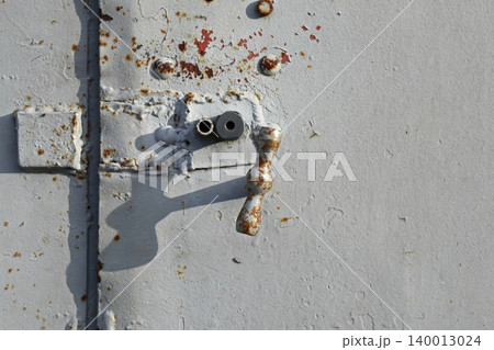 Rusted Metal Door Handle and Fittings on White Painted Surface, Weathered Industrial Detail Macro 140013024