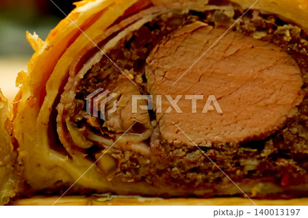 a Prepared meatloaf with dough roll cutting meatloaf. 140013197