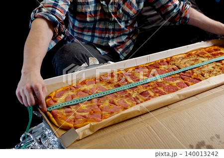 Measure pizza length with a tape measure Measure pizza length with a tape measure 140013242