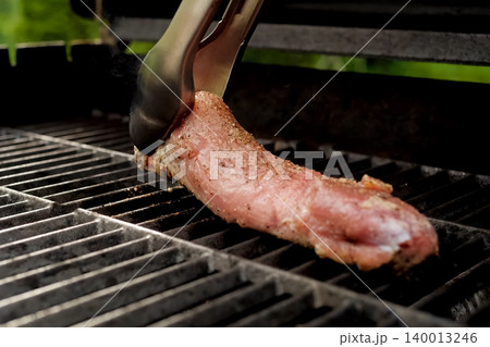 grilling pork meat. spices on meat. grilling pork meat. spices on meat. 140013246