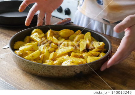 Fried potatoes with spices in pan. Spices on the potato. Fried potatoes with spices in pan. Spices on the potato. 140013249
