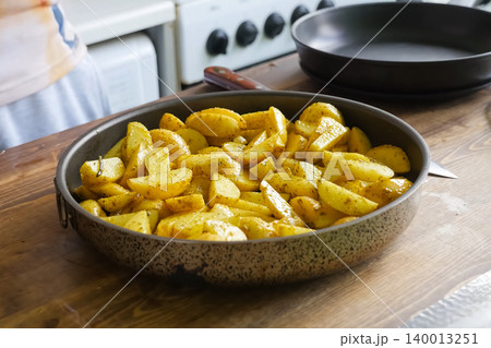 Fried potatoes with spices in pan. Spices on the potato. Fried potatoes with spices in pan. Spices on the potato. 140013251