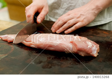 Cutting piece of pork meat on the table. Raw pork. 140013268