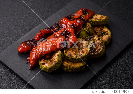 Grilled or barbecued sweet peppers and zucchini slices with salt. Grilled peppers and zucchini Grilled or barbecued sweet peppers and zucchini slices with salt. Grilled peppers and zucchini 140014908