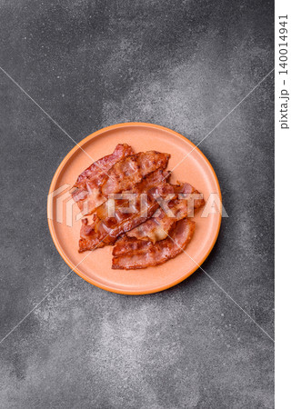 Fried fresh bacon slices with layers of meat or prosciutto with salt and spices. Fried bacon Fried fresh bacon slices with layers of meat or prosciutto with salt and spices. Fried bacon 140014941