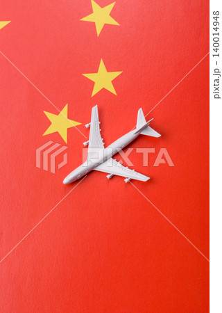 An airplane on the china flag as a conceptual backdrop for travel. An airplane on the china flag An airplane on the china flag as a conceptual backdrop for travel. An airplane on the china flag 140014948