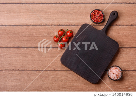 Empty wooden cutting board for preparing ingredients for home cooking. An empty cutting board 140014956