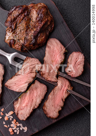 Beef mignon steak, rare, meat grilled with salt and spices. Beef steak Beef mignon steak, rare, meat grilled with salt and spices. Beef steak 140014998