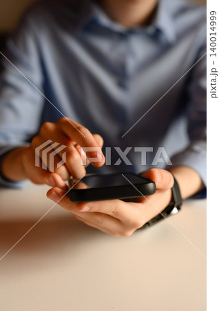 Conceptual background of men's hands with a smartphone for online shopping. Men's hands with a phone Conceptual background of men's hands with a smartphone for online shopping. Men's hands with a phone 140014999