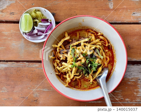 Top view of authentic Northern Thai beef khao soy noodle soup with side dishes. Top view of authentic Northern Thai beef khao soy noodle soup with side dishes. 140015037