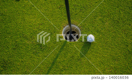 Golf balls on a green lawn in a beautiful golf course with morning sunshine. Golf balls on a green lawn in a beautiful golf course with morning sunshine. 140016036