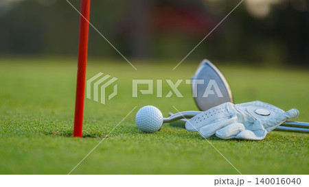 Golf balls on a green lawn in a beautiful golf course with morning sunshine. 140016040