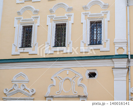 Architectural detail of a window and baroque wall decor on a church in Smolensk. Architectural detail of a window and baroque wall decor on a church in Smolensk. 140016141